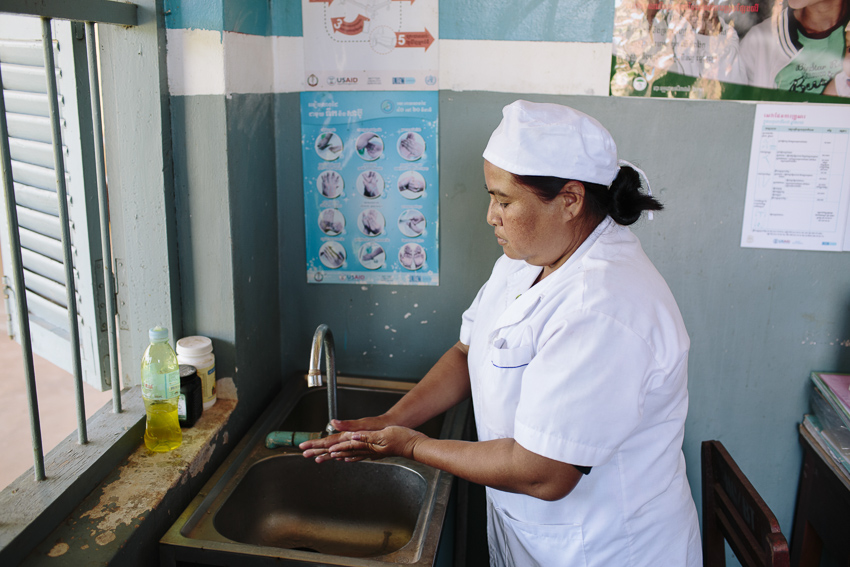 Midwife Ouk Sakon, 43, washes her hands at a sink. Boeung Kontout Health Centre, Krokor District, Pursat Province, Cambodia.