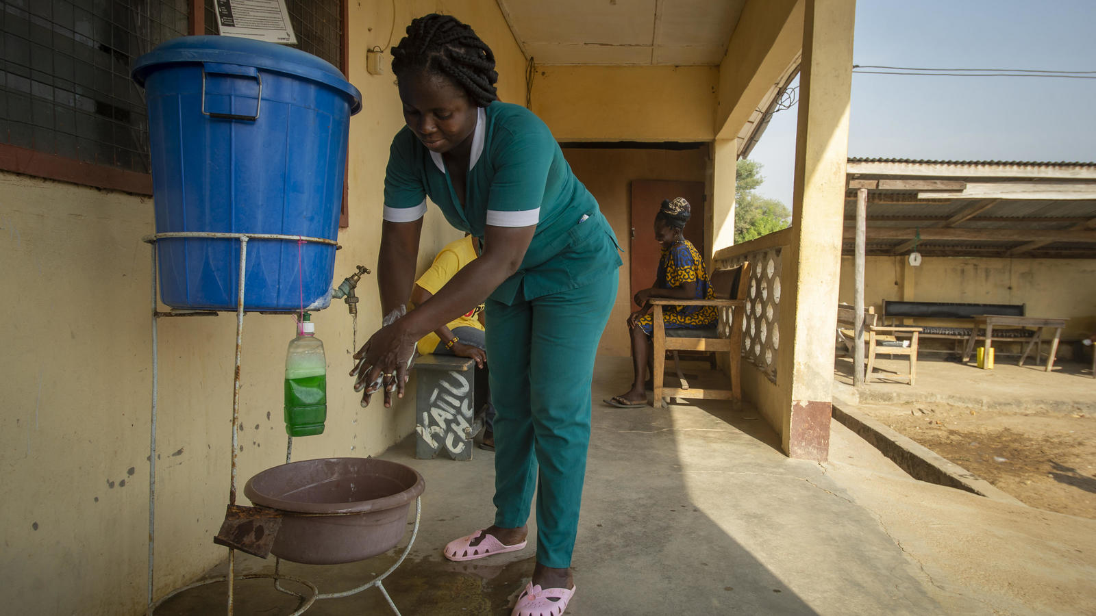 Midwife Fostina Sedjoah aged 36, washes her hands at the Katiu CHPS health centre, Katiu community, Kassena Nankana West District , Upper East Region, Ghana - February 2019